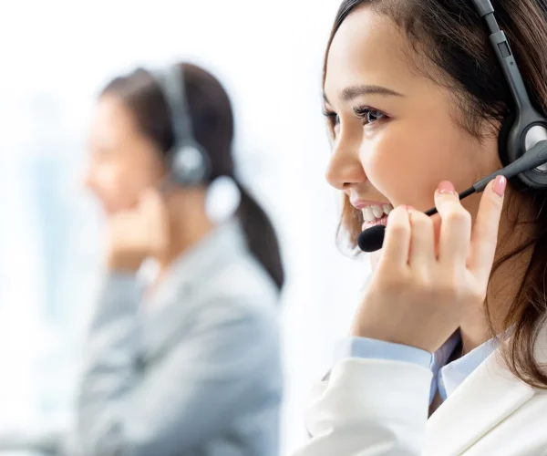 smiling-telemarketing-asian-woman-working-call-center-office